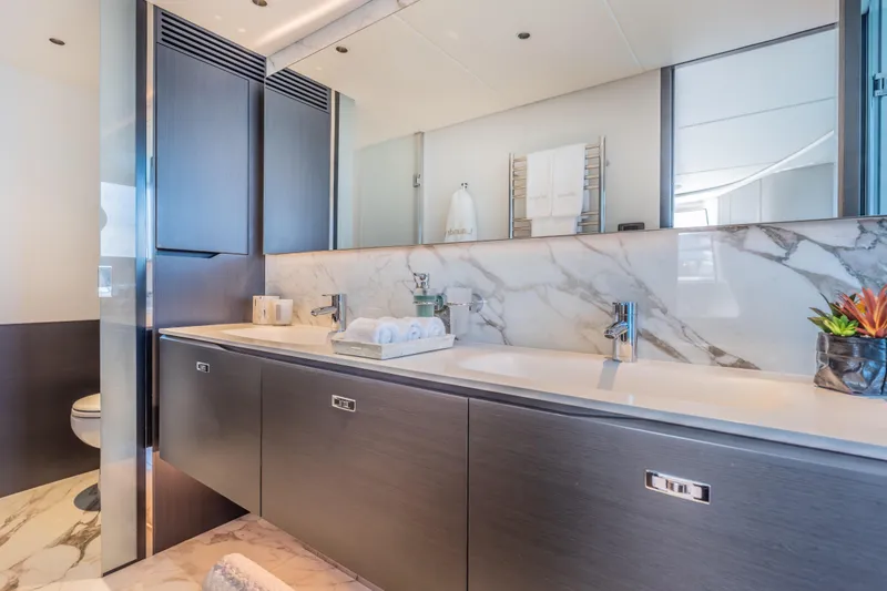 Gemini Yacht Photos Pics Luxurious bathroom in 2023 Princess X95 yacht with marble accents and modern fixtures.