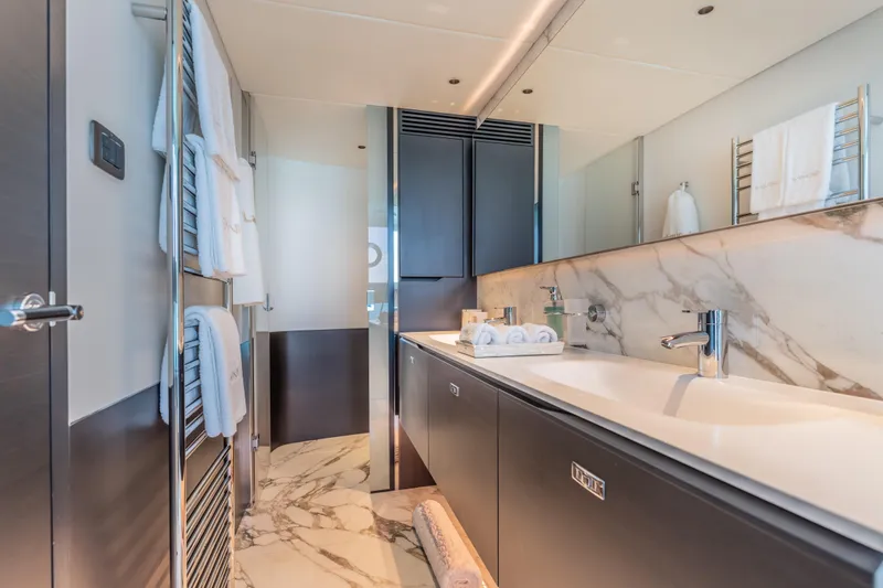 Gemini Yacht Photos Pics Luxurious bathroom interior on 2023 Princess X95 yacht with marble accents and modern fixtures.