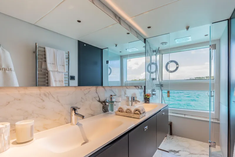 Gemini Yacht Photos Pics Luxurious bathroom on 2023 Princess X95 yacht with ocean view and elegant marble finishes.