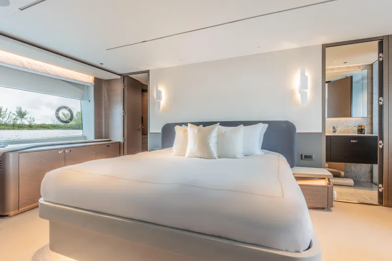 Gemini Yacht Photos Pics Luxurious bedroom interior of 2023 Princess X95 yacht, featuring modern design and elegant furnishings.