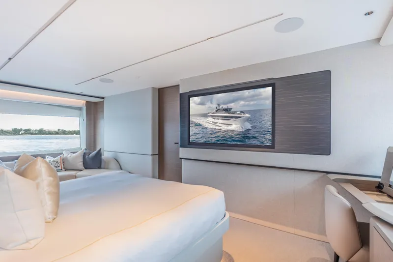 Gemini Yacht Photos Pics Luxurious interior of 2023 Princess X95 yacht with elegant bedroom and sea view.