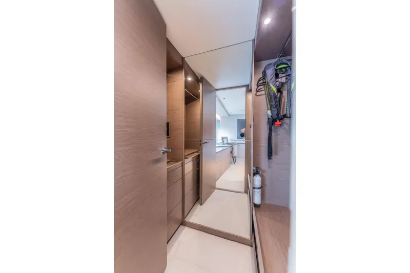 Gemini Yacht Photos Pics Luxurious interior hallway of 2023 Princess X95 yacht with modern wood finishes.