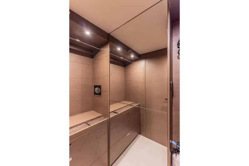 Gemini Yacht Photos Pics Luxurious interior of 2023 Princess X95 yacht with sleek wood paneling and modern lighting.