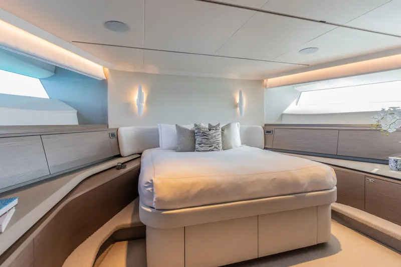 Gemini Yacht Photos Pics Luxurious bedroom interior of 2023 Princess X95 yacht with modern design and ambient lighting.