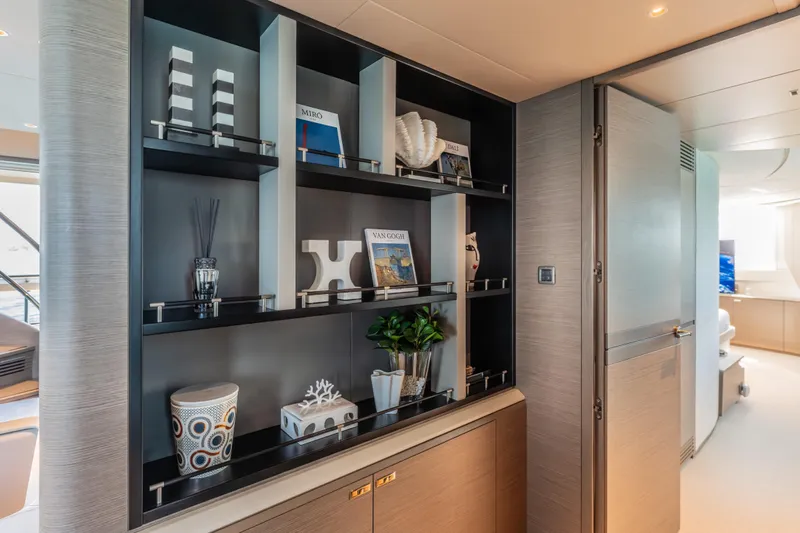 Gemini Yacht Photos Pics Luxurious interior of 2023 Princess X95 yacht with elegant shelving and decor.