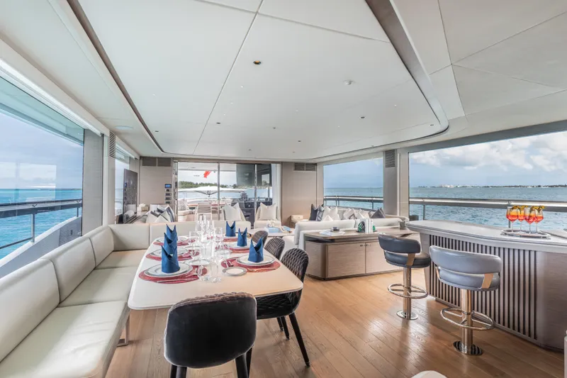 Gemini Yacht Photos Pics Luxurious interior of 2023 Princess X95 yacht with elegant dining and seating areas.