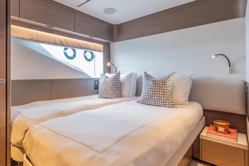 Gemini Yacht Photos Pics Luxurious cabin interior of 2023 Princess X95 yacht with twin beds and modern decor.