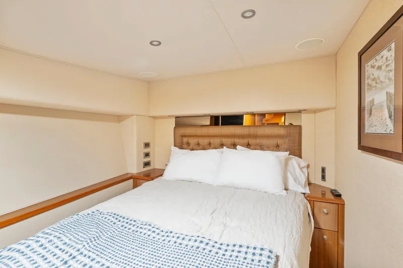  Yacht Photos Pics Luxurious bedroom interior of 2008 Viking Convertible yacht with cozy bedding and elegant decor.