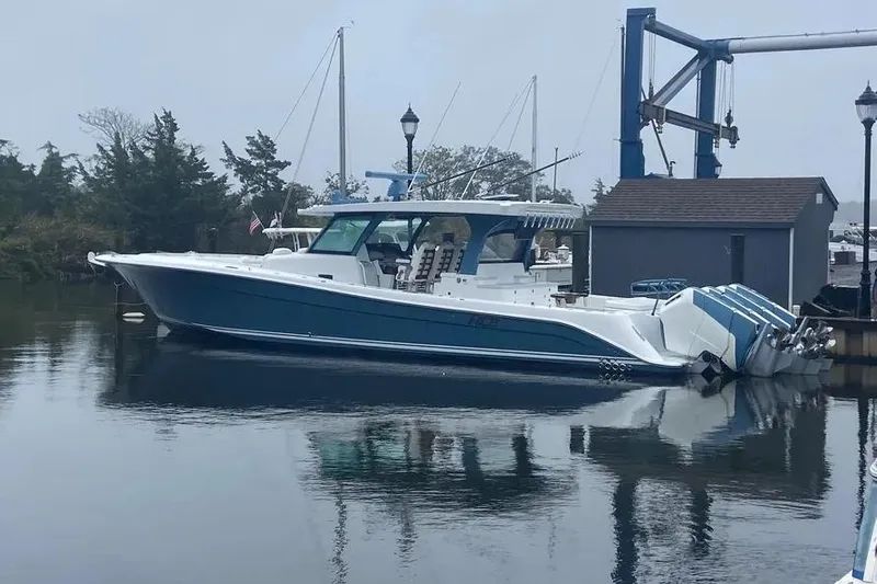  Yacht Photos Pics 2025 HCB 48 Campeon boat docked in a marina, featuring sleek design and powerful engines.