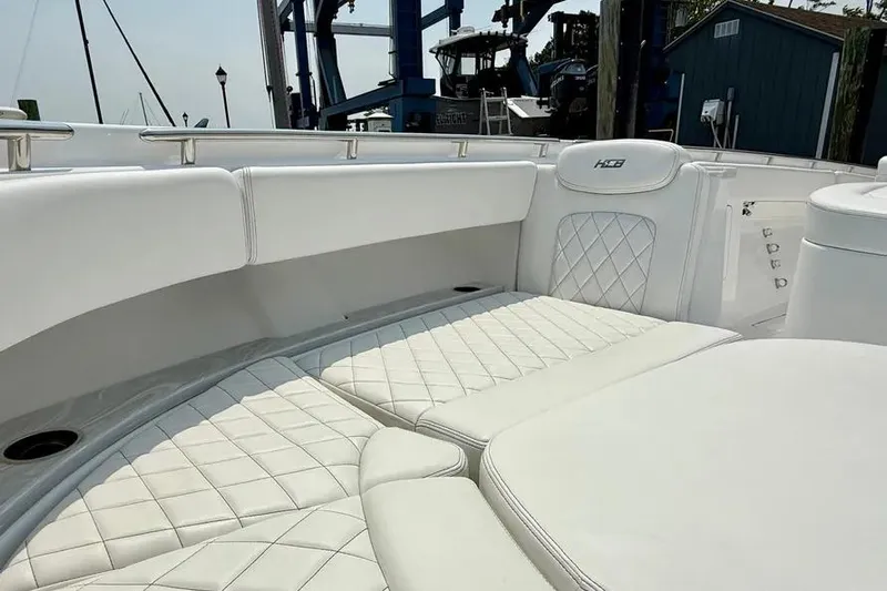  Yacht Photos Pics Luxurious seating on 2025 HCB 48 Campeon boat with quilted white upholstery.