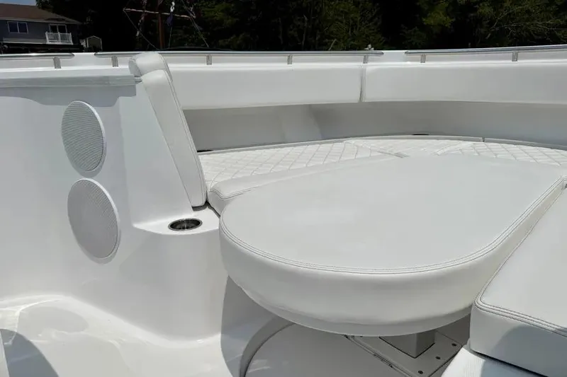  Yacht Photos Pics Luxurious seating on 2025 HCB 48 Campeon boat, featuring white upholstery and speakers.