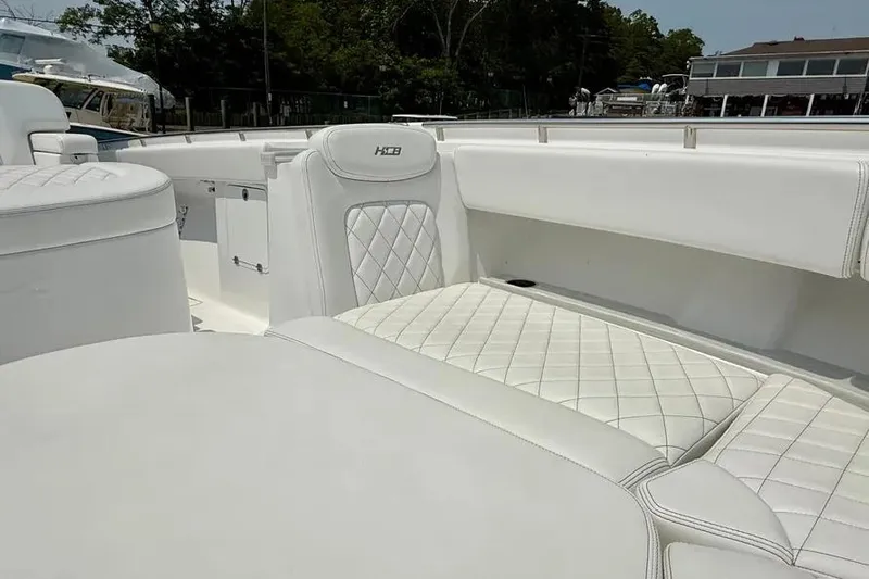  Yacht Photos Pics 2025 HCB 48 Campeon boat interior with luxurious white quilted seating.