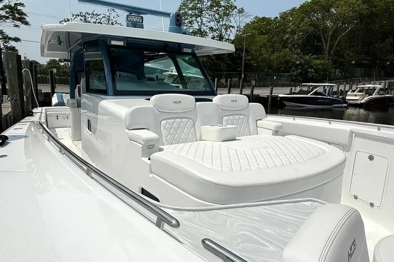  Yacht Photos Pics 2025 HCB 48 Campeon luxury boat with white seating and sleek design at a marina.