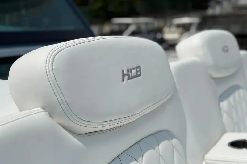  Yacht Photos Pics White leather seats on 2025 HCB 48 Campeon boat, featuring embroidered logo.
