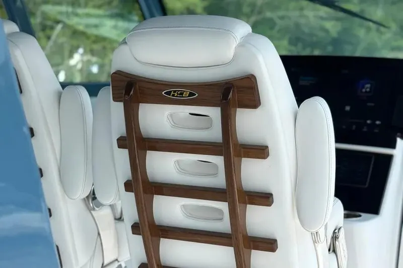  Yacht Photos Pics Luxury seating in 2025 HCB 48 Campeon boat, featuring elegant wood and leather design.