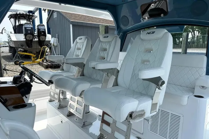  Yacht Photos Pics Luxury seating on 2025 HCB 48 Campeon boat, featuring white leather and modern design.