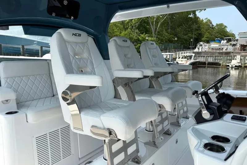  Yacht Photos Pics Luxury seating on 2025 HCB 48 Campeon boat, featuring white leather and sleek design.