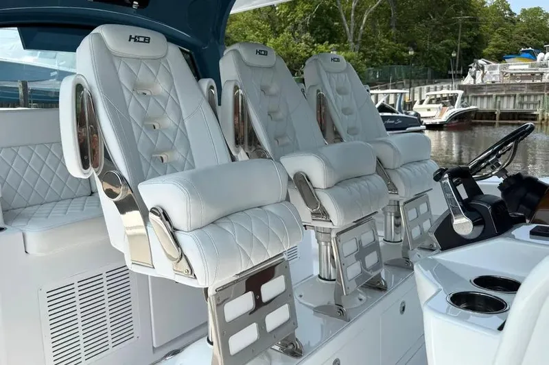  Yacht Photos Pics Luxurious seating on 2025 HCB 48 Campeon boat, featuring white quilted leather and chrome accents.