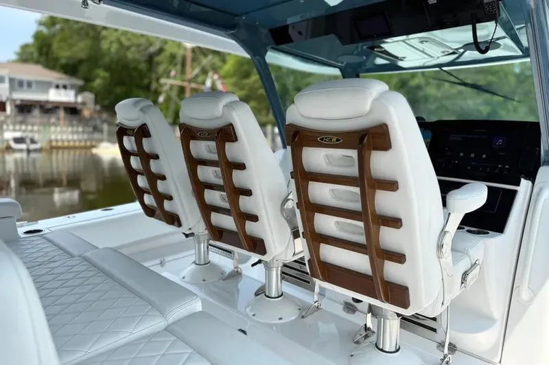  Yacht Photos Pics Luxury seating on 2025 HCB 48 Campeon boat, featuring elegant white and wood design.