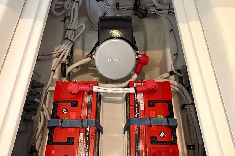  Yacht Photos Pics 2025 HCB 48 Campeon boat engine compartment with red batteries and wiring.