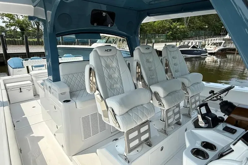  Yacht Photos Pics Luxury interior of 2025 HCB 48 Campeon boat with plush seating and modern controls.