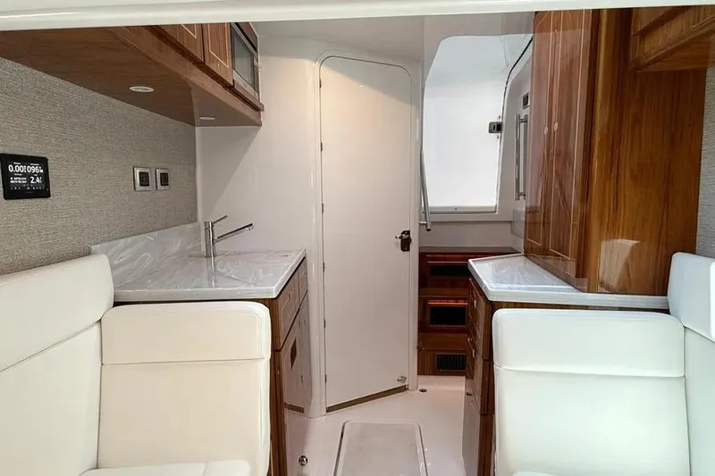  Yacht Photos Pics Luxurious interior of 2025 HCB 48 Campeon yacht with modern furnishings and wood accents.