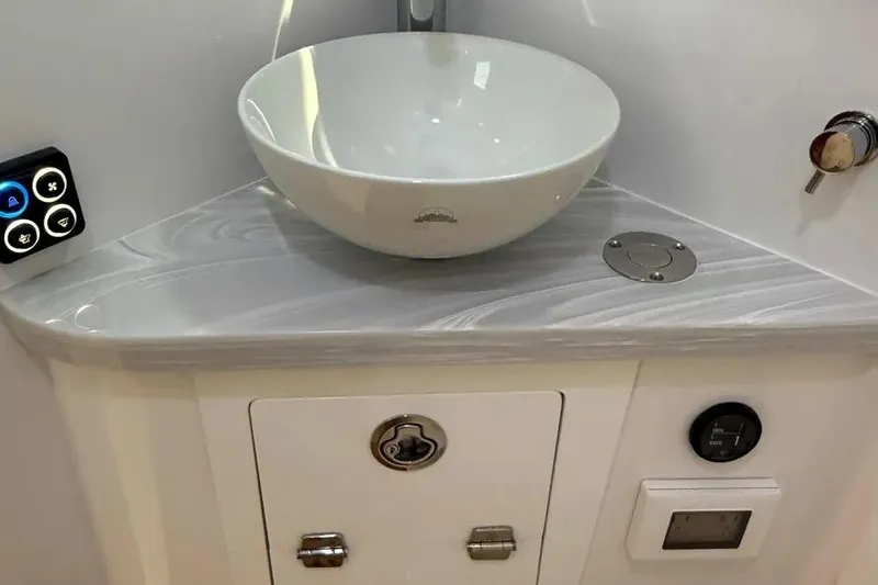  Yacht Photos Pics Modern bathroom sink in 2025 HCB 48 Campeon boat, featuring sleek design and control panel.