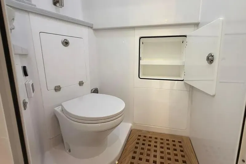  Yacht Photos Pics 2025 HCB 48 Campeon yacht bathroom with toilet and storage cabinet.