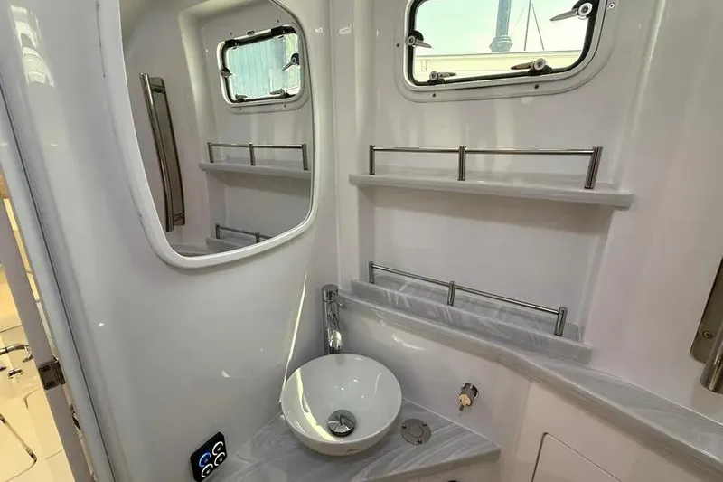  Yacht Photos Pics Modern bathroom interior of 2025 HCB 48 Campeon yacht, featuring sleek sink and windows.