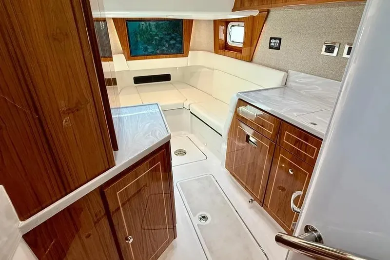  Yacht Photos Pics Luxurious interior of 2025 HCB 48 Campeon yacht with wood cabinetry and white seating.
