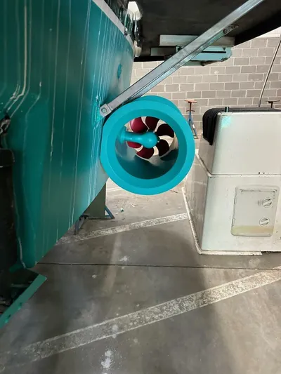 Gran Vida Yacht Photos Pics 1998 Ocean Yachts Super Sport with turquoise bow thruster in a garage setting.