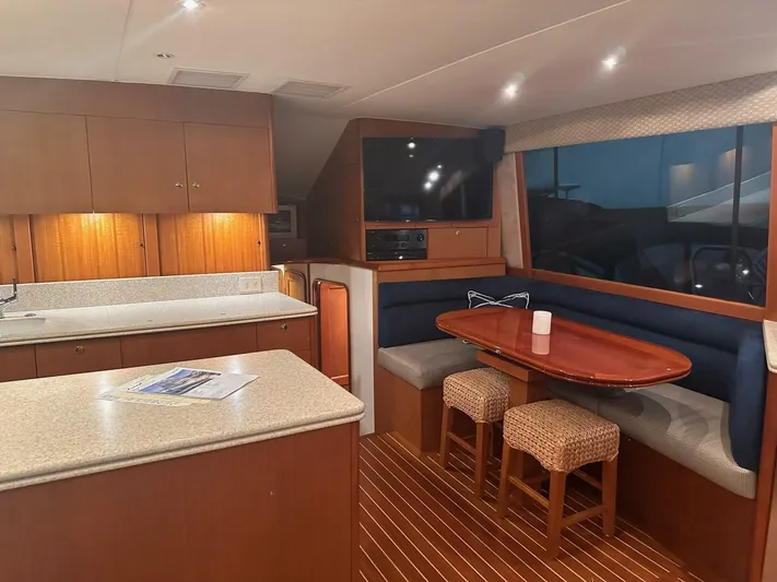 Gran Vida Yacht Photos Pics Luxurious 1998 Ocean Yachts Super Sport interior with kitchen and dining area.