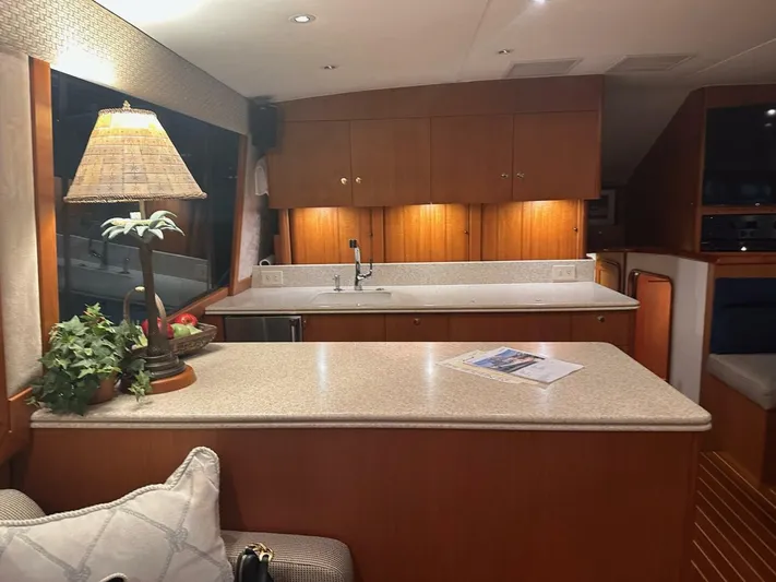 Gran Vida Yacht Photos Pics Luxurious interior of a 1998 Ocean Yachts Super Sport with elegant wood cabinetry and countertop.