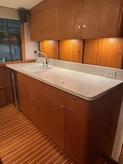 Gran Vida Yacht Photos Pics 1998 Ocean Yachts Super Sport kitchen with wooden cabinets and countertop.