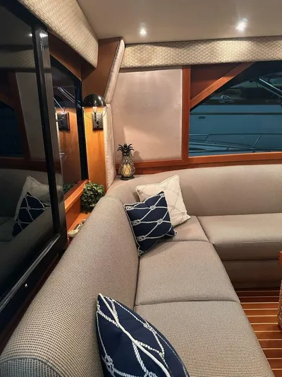 Gran Vida Yacht Photos Pics Interior of 1998 Ocean Yachts Super Sport with cozy seating and nautical decor.