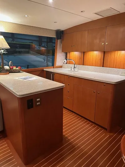 Gran Vida Yacht Photos Pics Luxurious kitchen interior of 1998 Ocean Yachts Super Sport with wooden cabinetry and modern amenities.