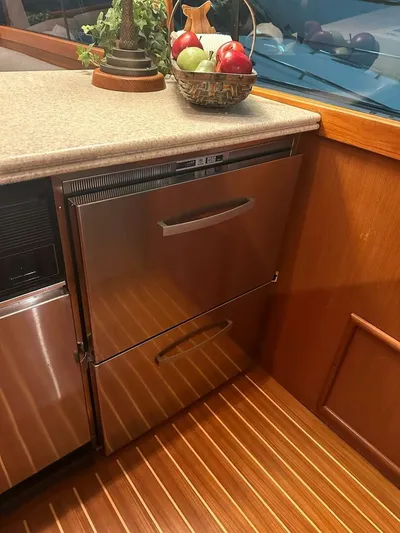 Gran Vida Yacht Photos Pics Stainless steel drawers in 1998 Ocean Yachts Super Sport kitchen with wooden flooring.