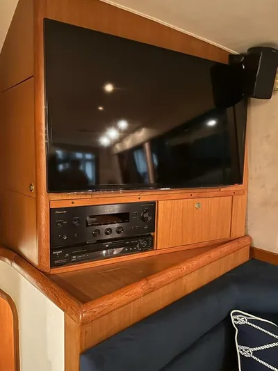 Gran Vida Yacht Photos Pics Entertainment system on a 1998 Ocean Yachts Super Sport, featuring a large TV and audio equipment.
