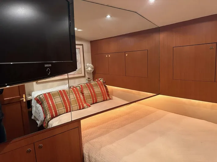 Gran Vida Yacht Photos Pics Luxurious cabin interior of 1998 Ocean Yachts Super Sport with cozy bedding and modern amenities.