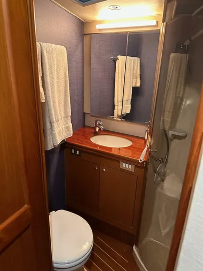 Gran Vida Yacht Photos Pics 1998 Ocean Yachts Super Sport bathroom with wooden cabinetry, sink, and shower.