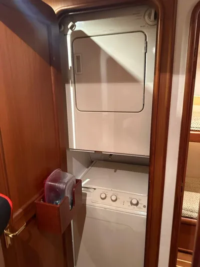 Gran Vida Yacht Photos Pics Laundry area with stacked washer and dryer in 1998 Ocean Yachts Super Sport.