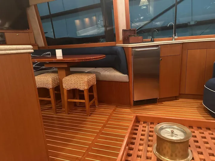 Gran Vida Yacht Photos Pics Interior of a 1998 Ocean Yachts Super Sport with wooden flooring and seating area.