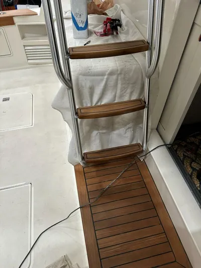 Gran Vida Yacht Photos Pics 1998 Ocean Yachts Super Sport interior with wooden ladder and deck, cleaning supplies visible.