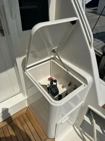 Gran Vida Yacht Photos Pics Open storage compartment on 1998 Ocean Yachts Super Sport boat, featuring control levers.