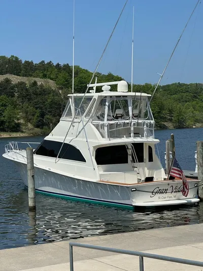 Gran Vida Yacht Photos Pics 1998 Ocean Yachts Super Sport docked in a scenic marina setting.