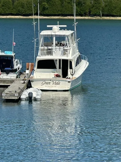 Gran Vida Yacht Photos Pics 1998 Ocean Yachts Super Sport boat docked on calm water.