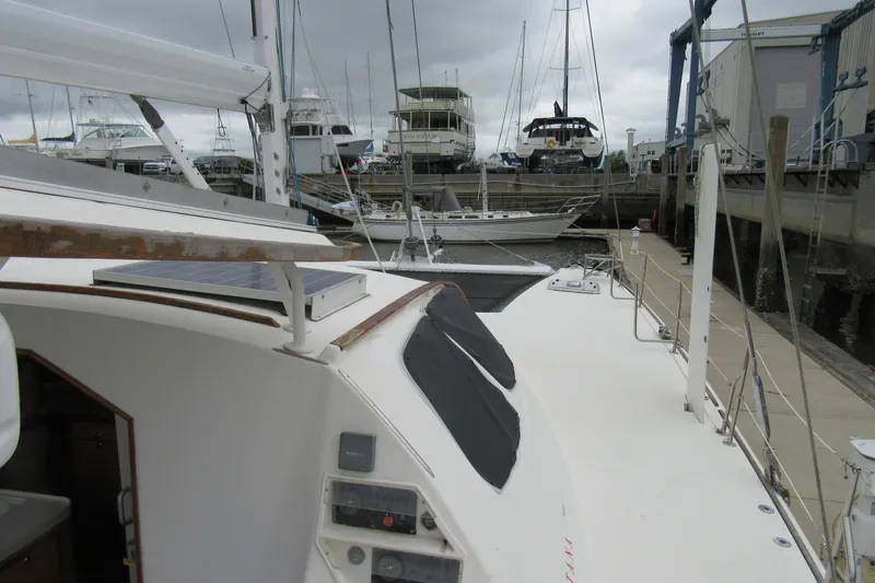 Pippin Yacht Photos Pics 2001 Catana 471 catamaran docked at marina with overcast sky.