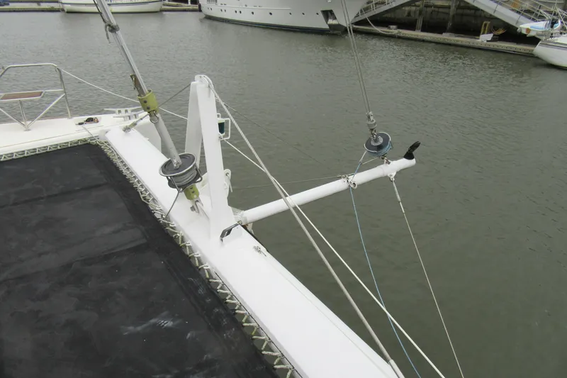 Pippin Yacht Photos Pics Catana 471 catamaran deck view, showcasing rigging and netting, docked in marina.