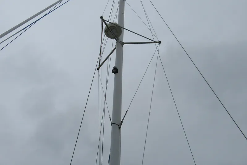 Pippin Yacht Photos Pics Mast of 2001 Catana 471 sailboat against cloudy sky.