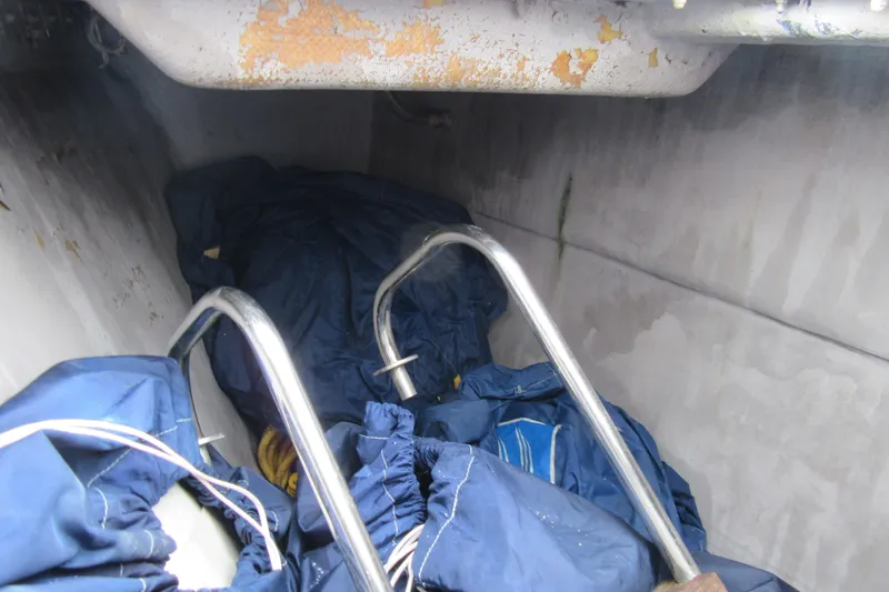 Pippin Yacht Photos Pics Interior of a 2001 Catana 471 sailboat with stored equipment and metal bars.